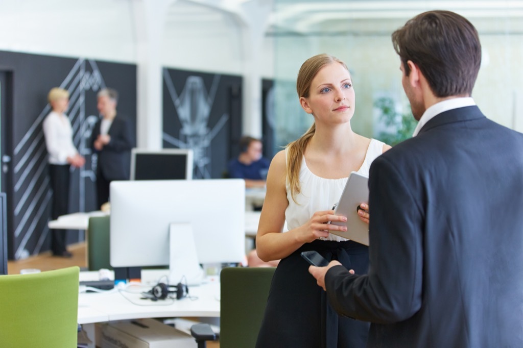 Woman talking to her boss at work.