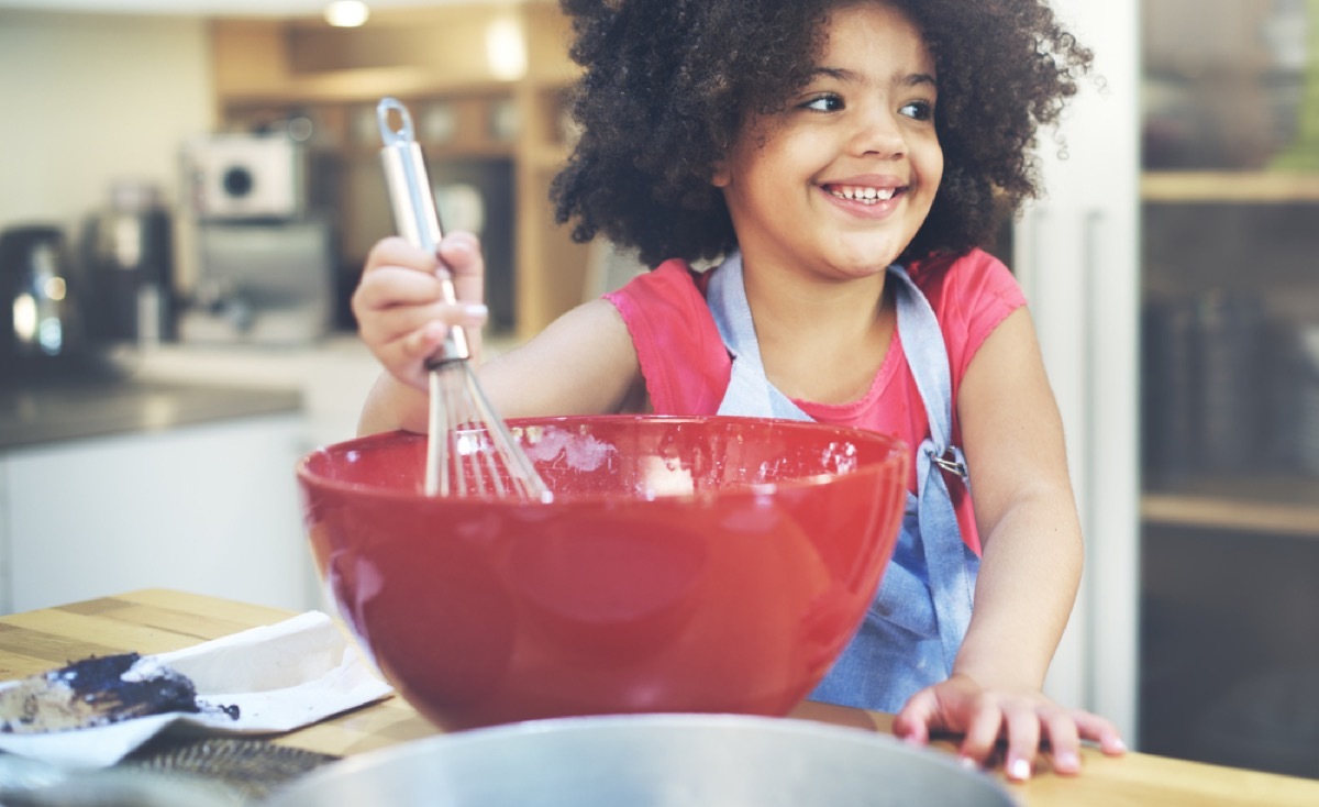 little girl whisking cake batter, fire prevention tips