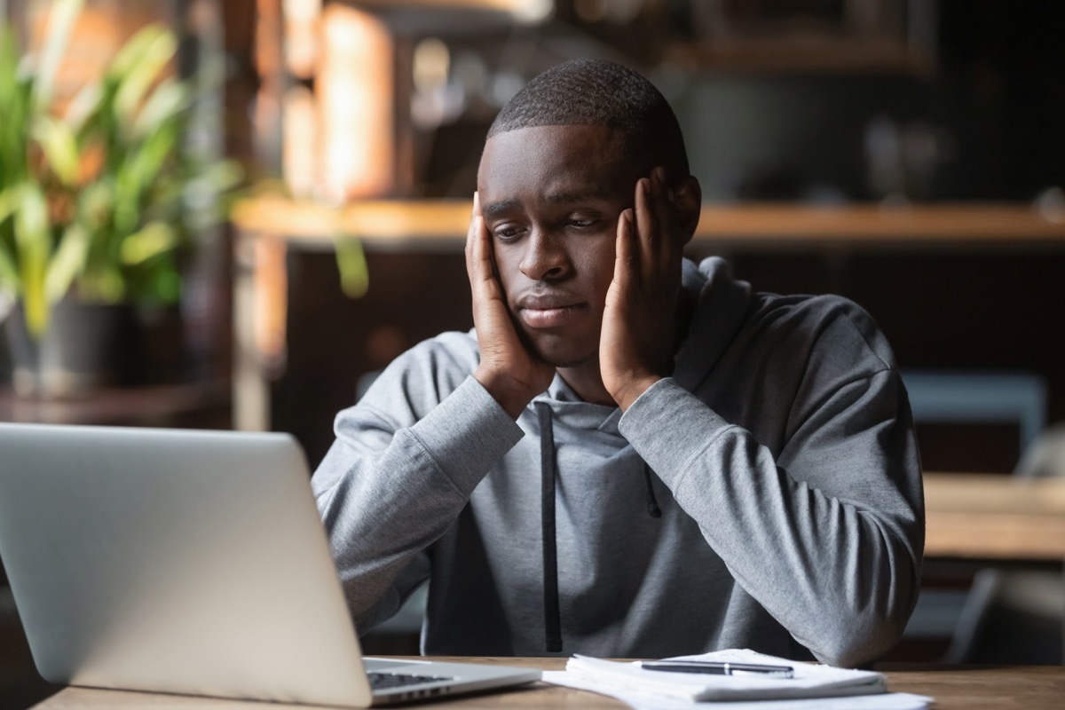 Black Man Looking Sad and Alone at Work Things that hurt your health