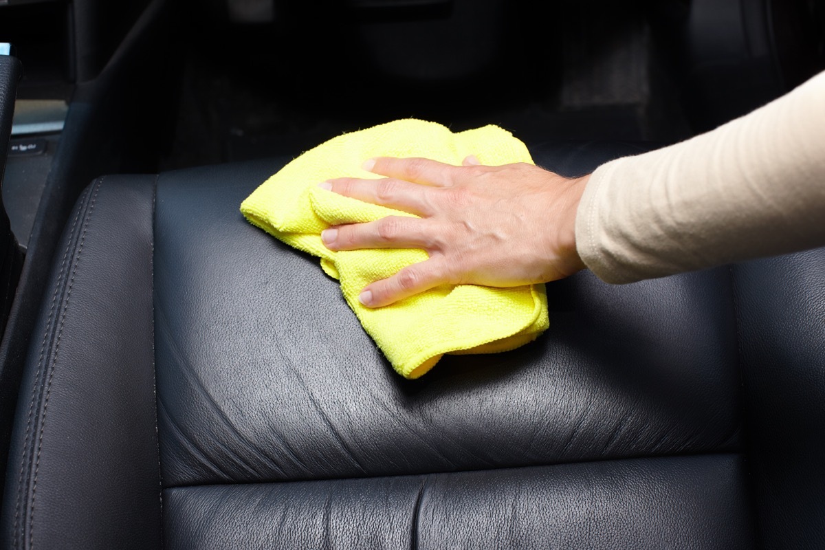 Cleaning car interior with towel