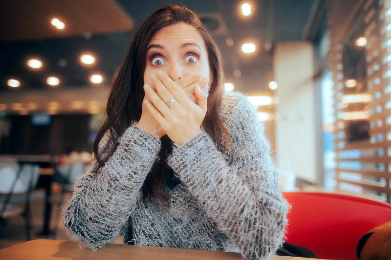 woman surprised covering mouth