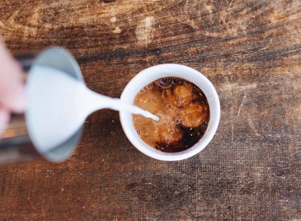 milk being poured into coffee