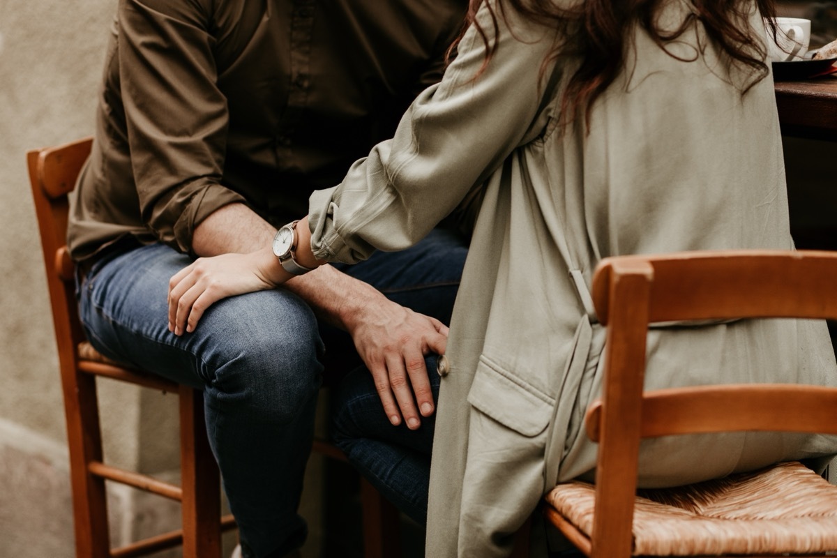 A couple in love sitting in front of one another. 