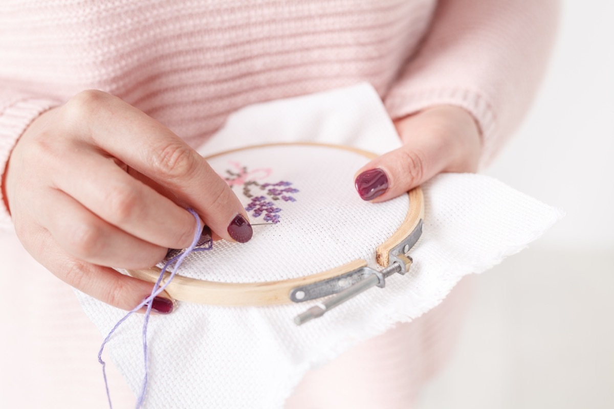 Woman doing cross stitch