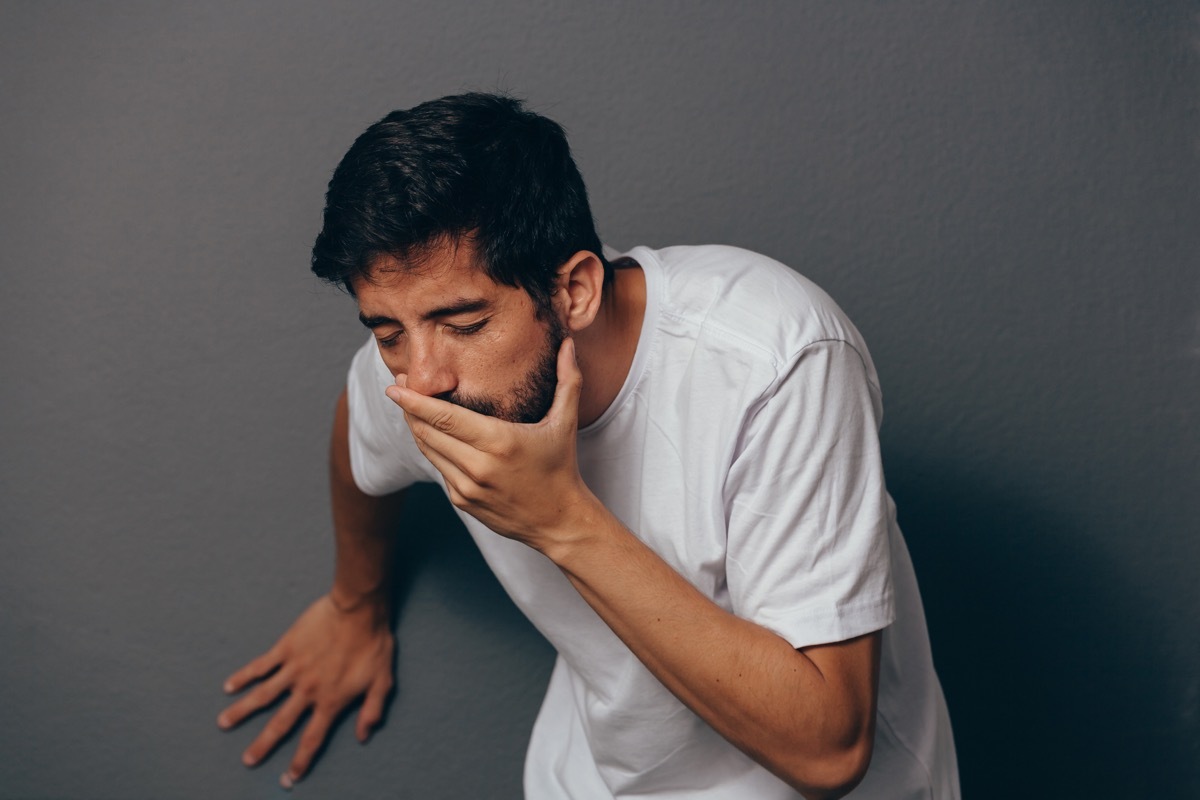 young hispanic man throwing up