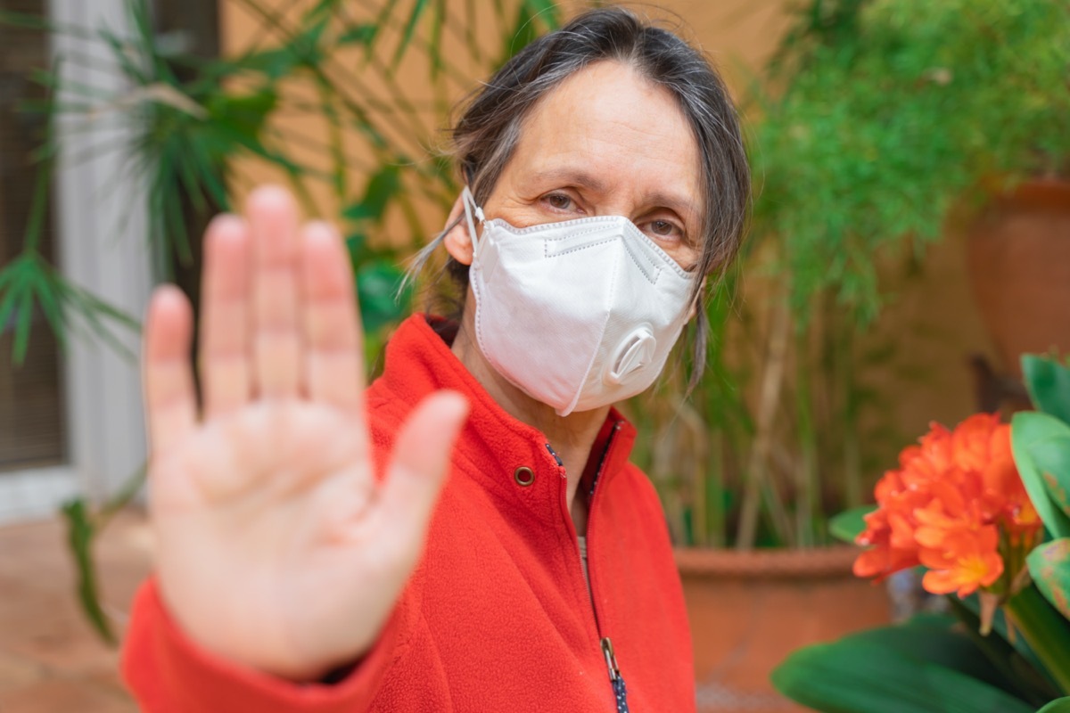 Sick woman isolated facing COVID-19. Corona virus wearing mask protection and recovery from the illness at home