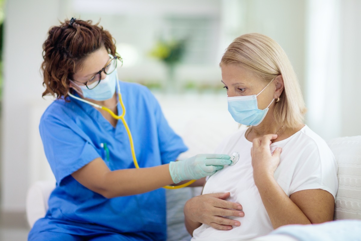 woman with oxygen mask at hospital