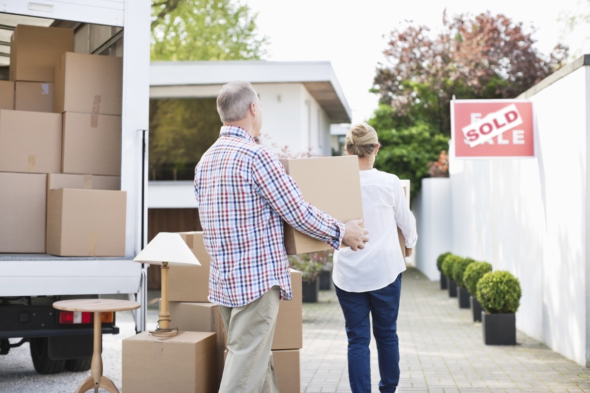 couple unloading their boxes when moving stuff out of a moving truck