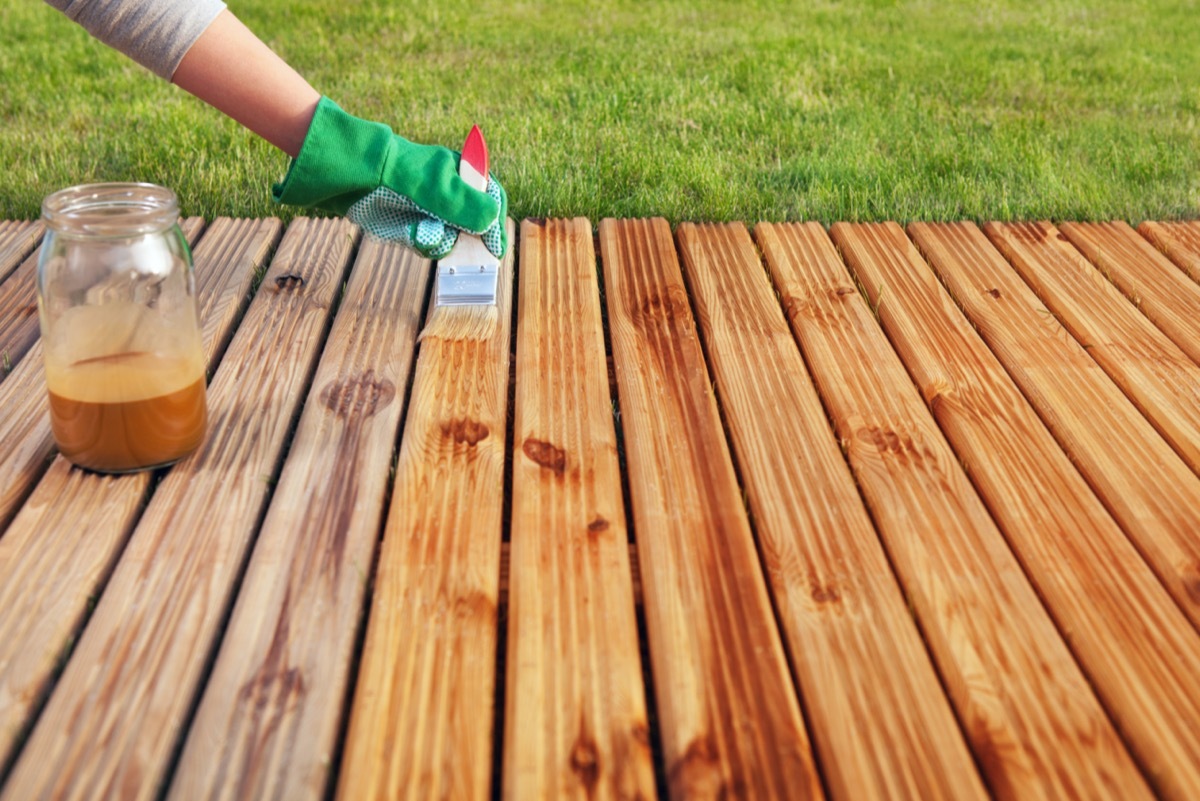 white hand waterproofing deck