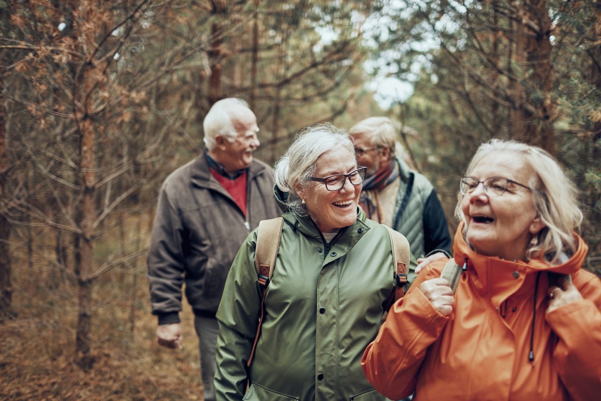 two older white women and two older white men hiking outdoors