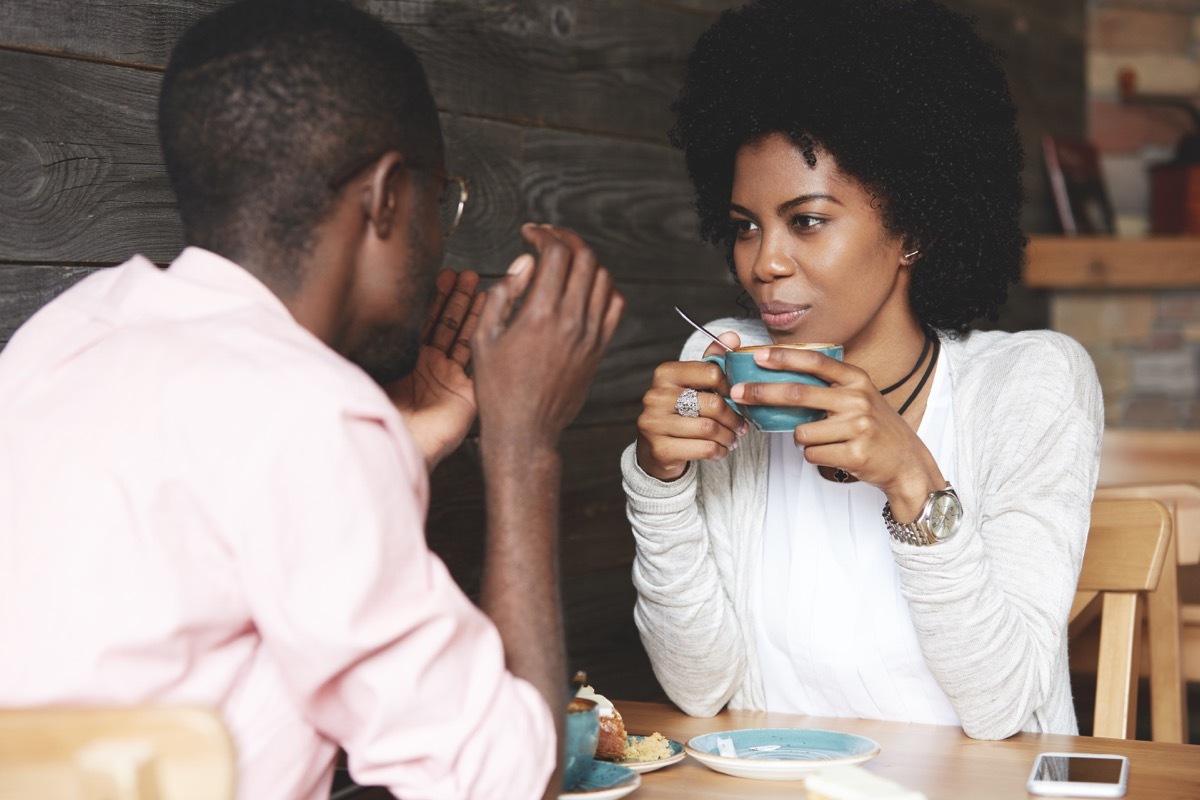 Couple talking over coffee in shop