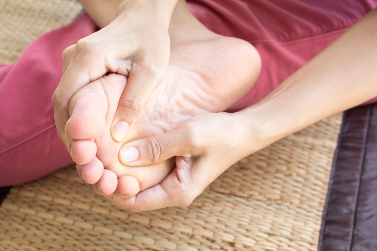 Woman checking her foot for any issues