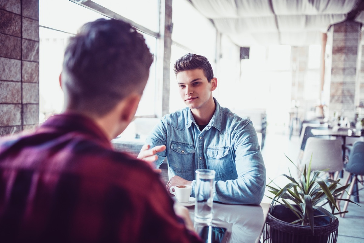 men Having tense conversation over coffee