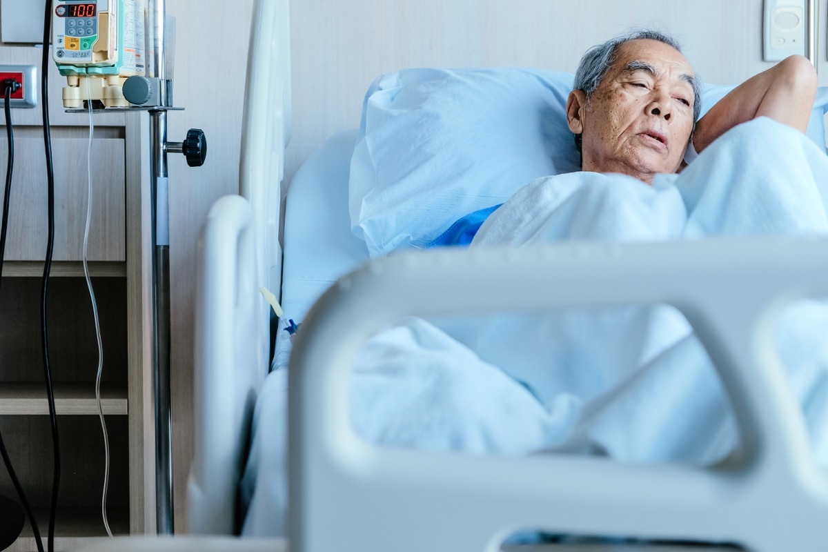 Older Asian Man Lying in a Hospital Bed Misdiagnosed Men's Health Issues