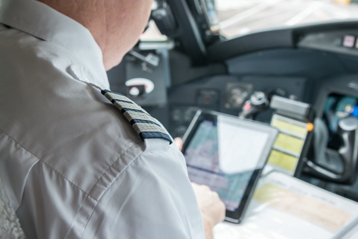 pilot checking his tablet