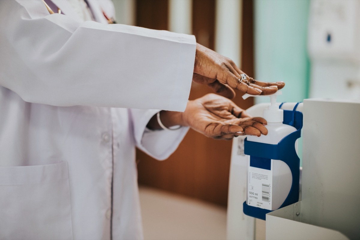 Female physician disinfecting her hands