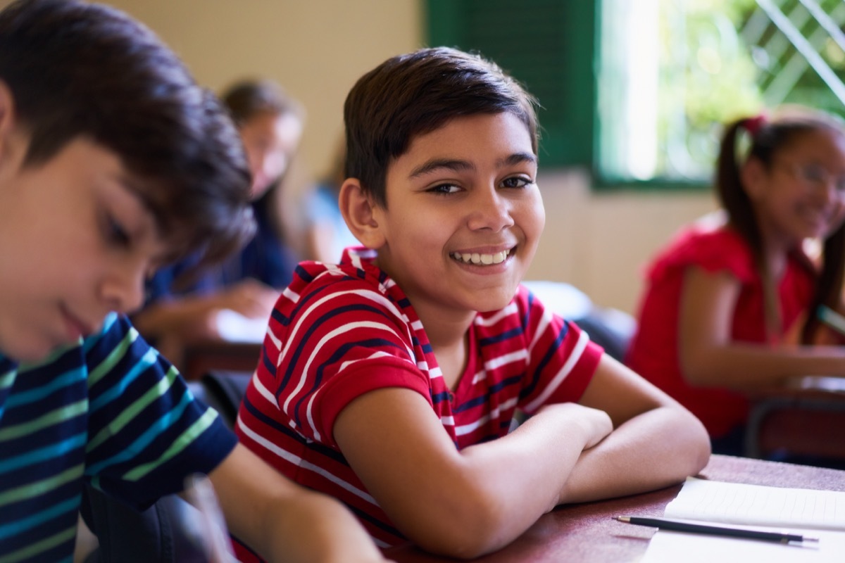 kid smiling in class, class clown, middle child