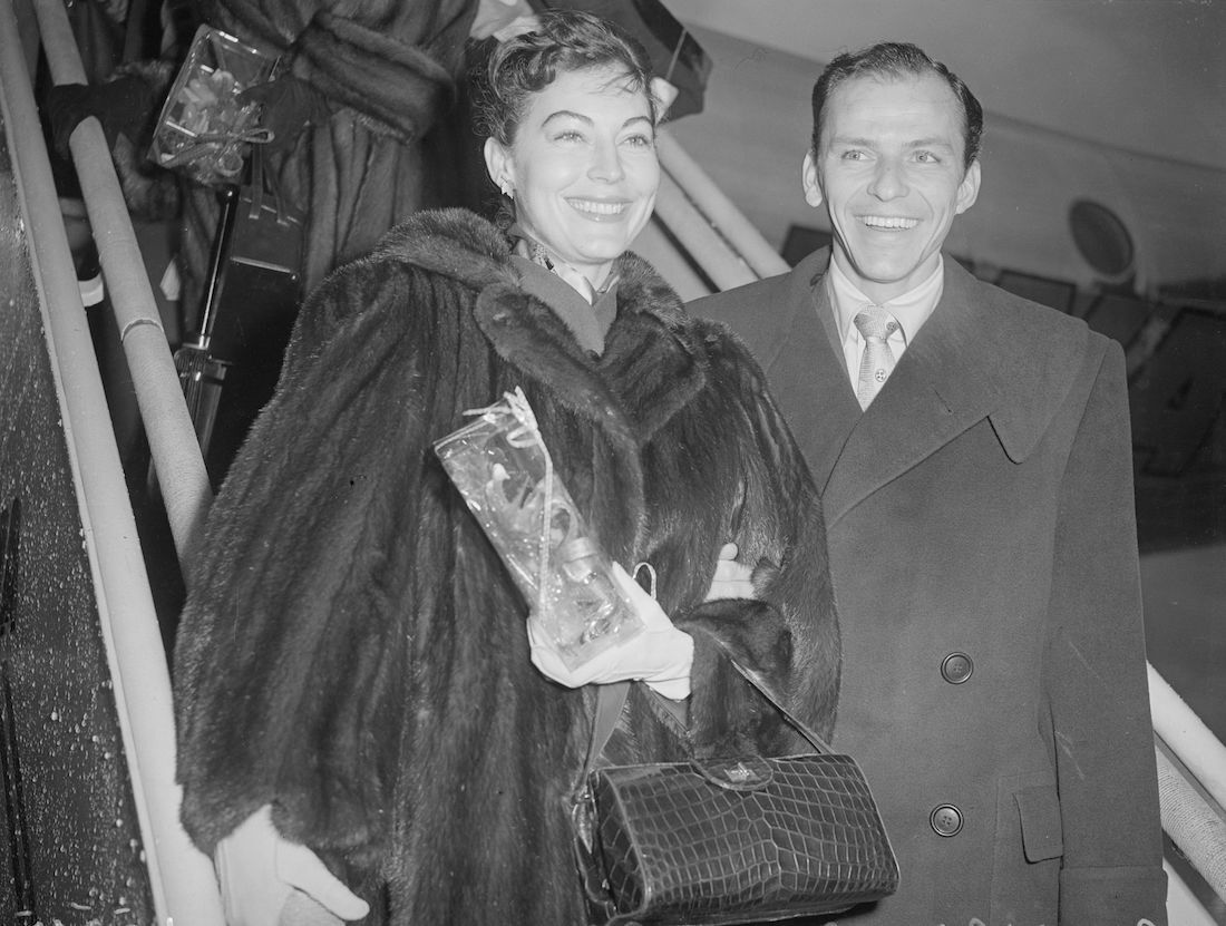 Ava Gardner and Frank Sinatra stepping off of a plane circa 1950