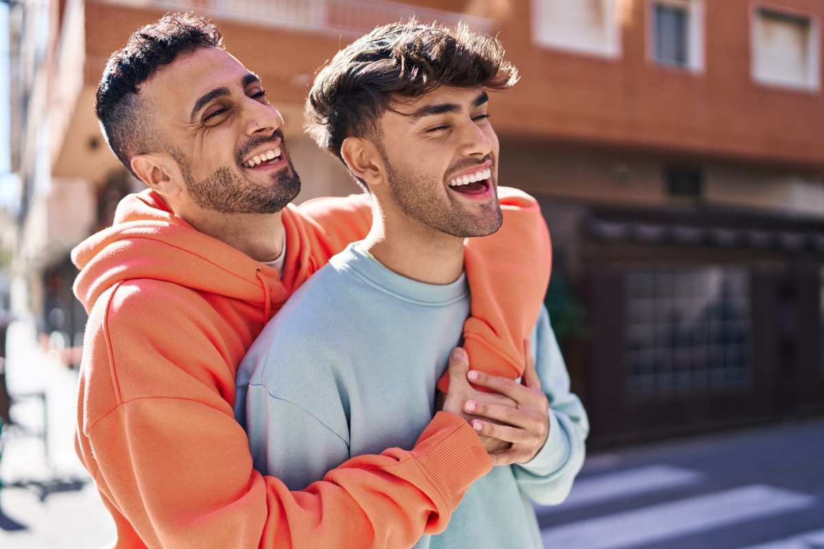 two men hugging on the street