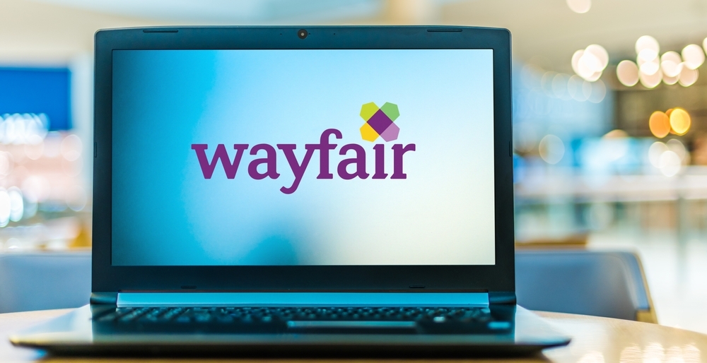 A laptop with the Wayfair logo on the screen