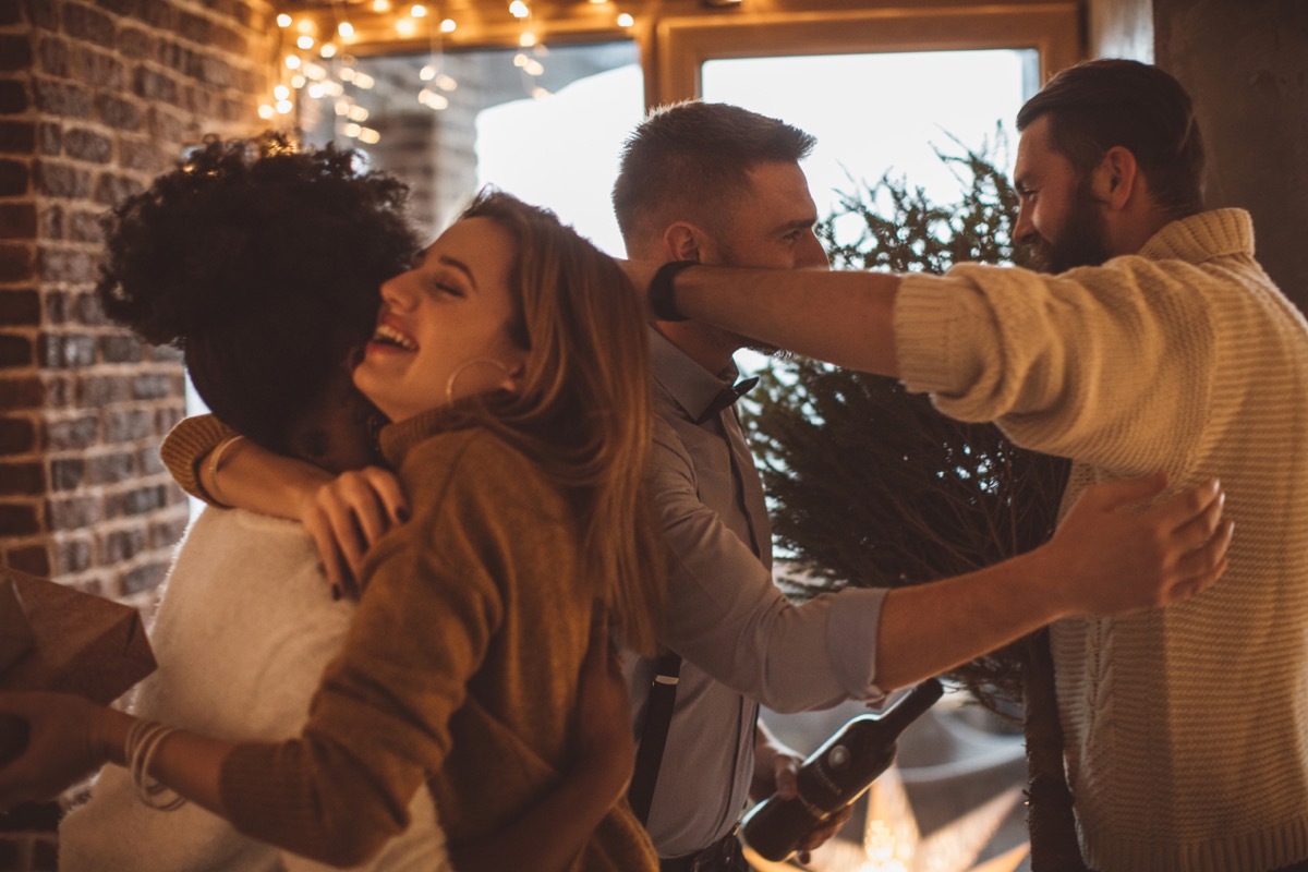 Group of friends gathered at home to celebrate Christmas or New Year. 