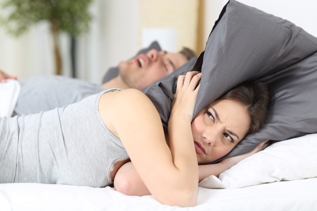 snoring couple in bed