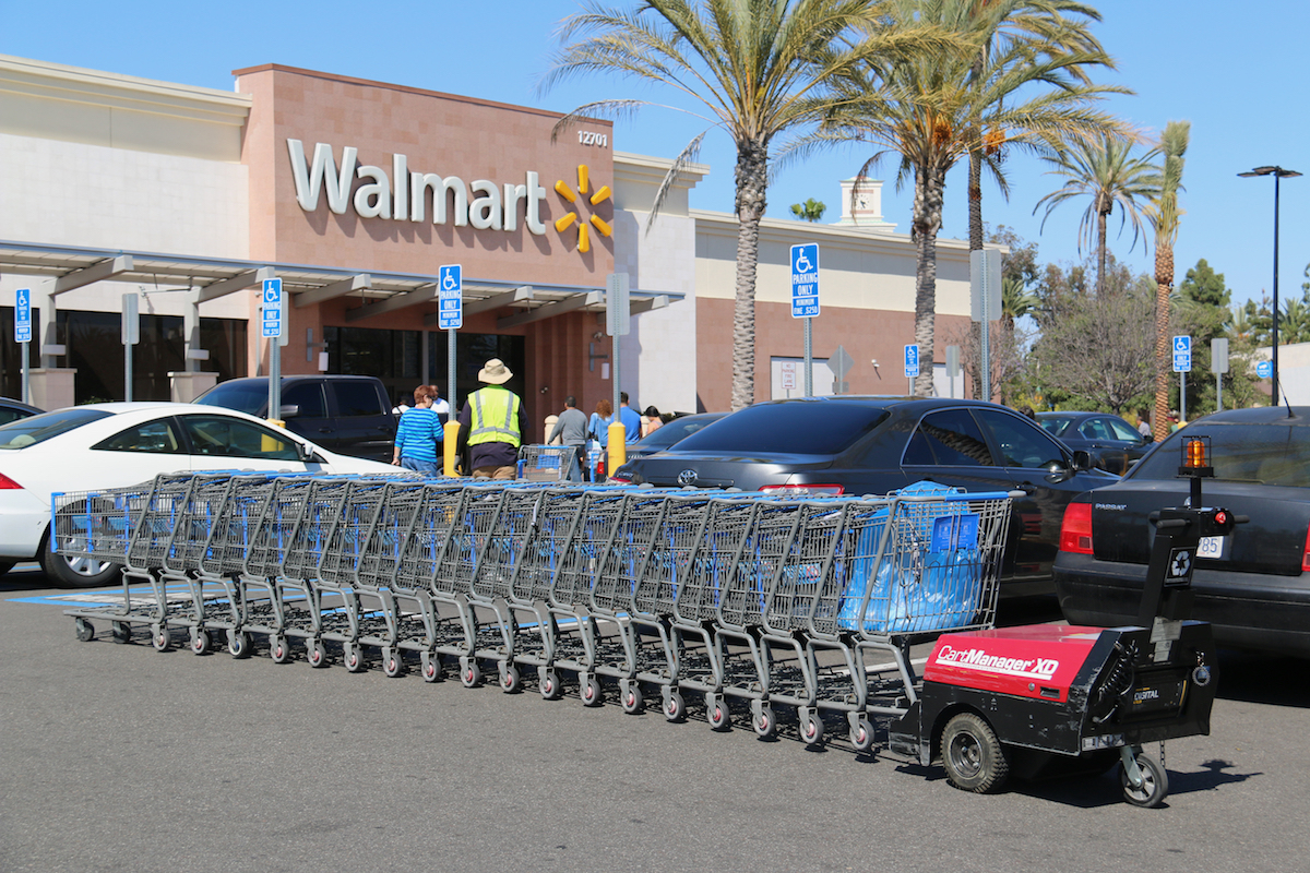 Cerritos, California, USA - April 18, 2016: Carts in parking lot are being pushed by CartManager XD, a shopping cart pusher, to make cart retrieval more efficient and safe.