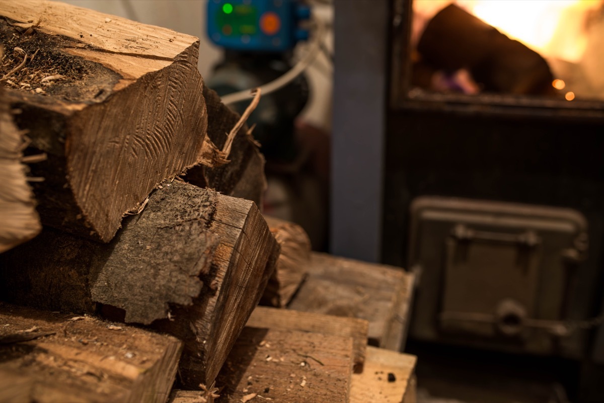 firewood pile in basement next to furnace