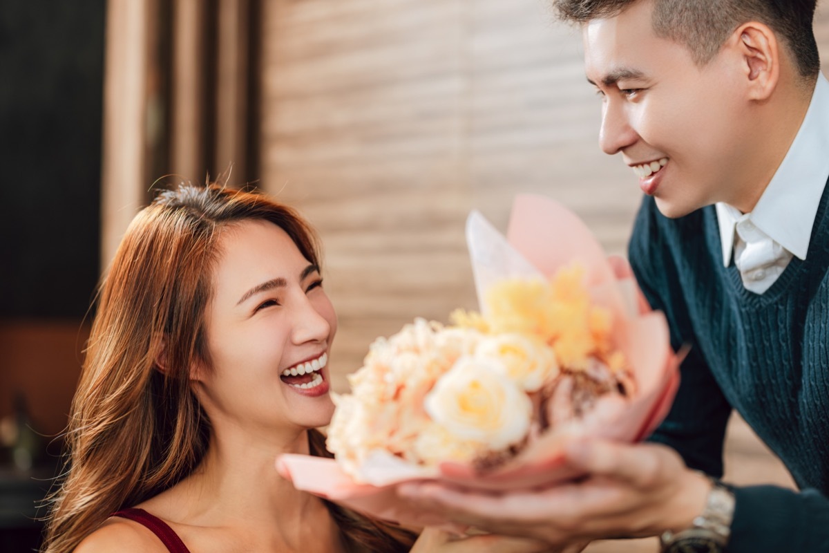 man bringing a woman flowers