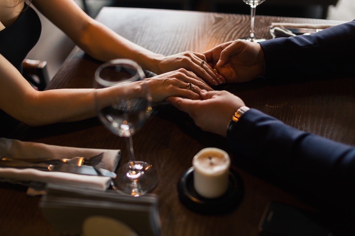 Holding hands across the table on a date