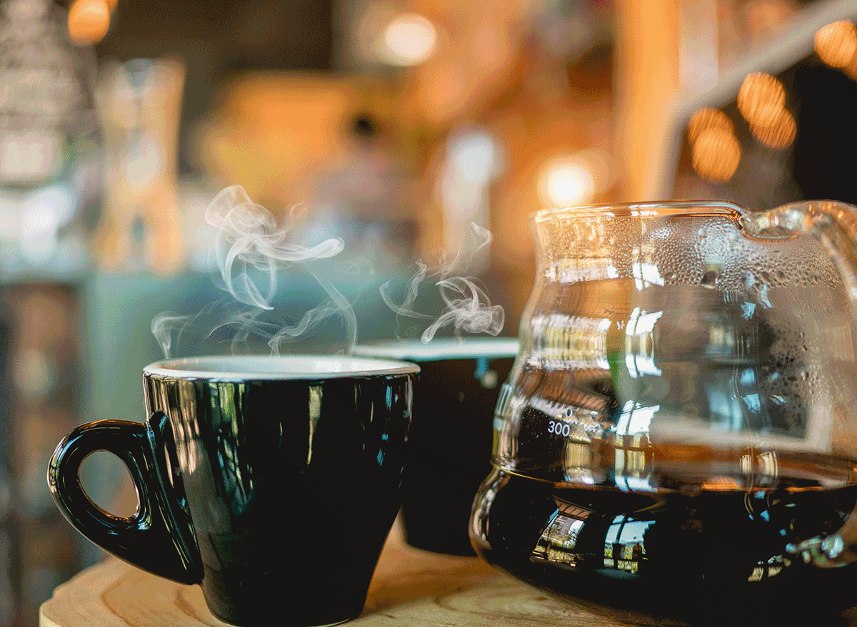 steaming hot coffee mug next to pot