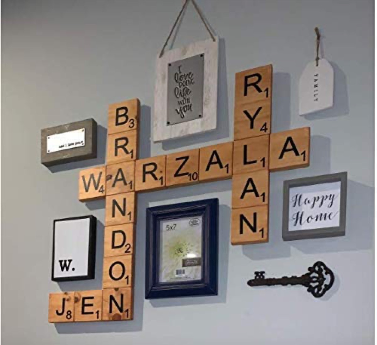 oversized wooden tiles interspersed with picture frames on blue wall