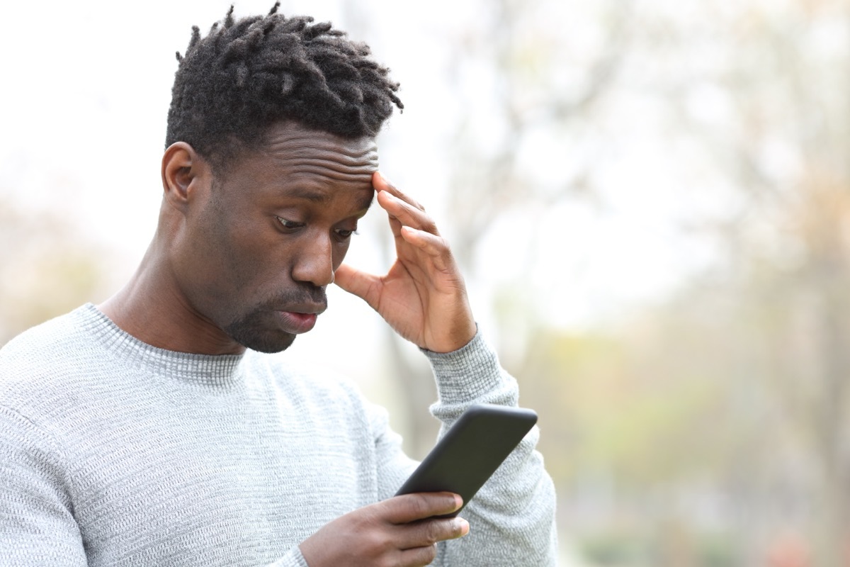 Man upset looking at his phone.