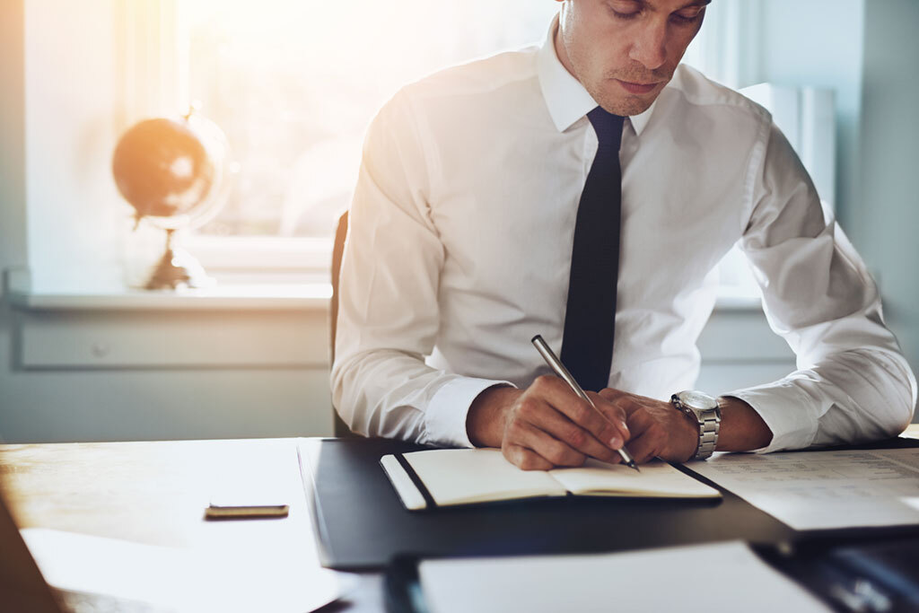 man sitting down at his desk and working ways we're unhealthy