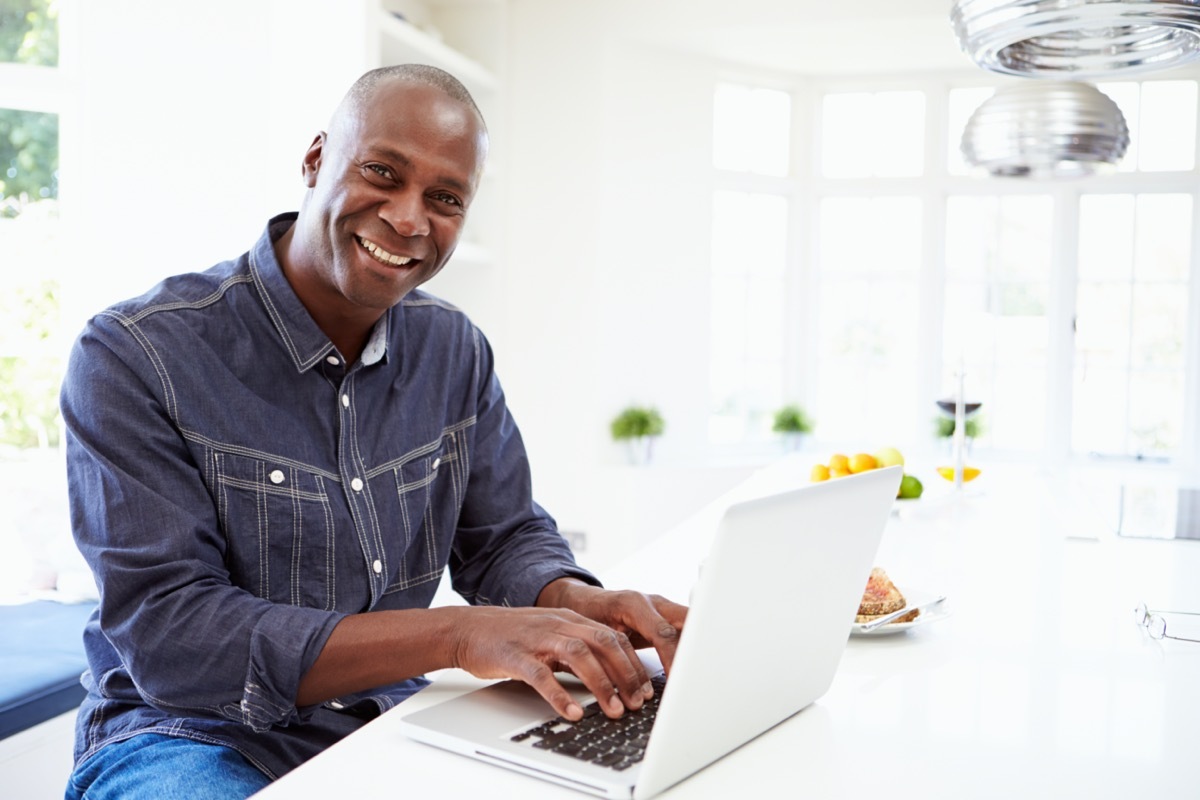 Man Using Laptop At Home