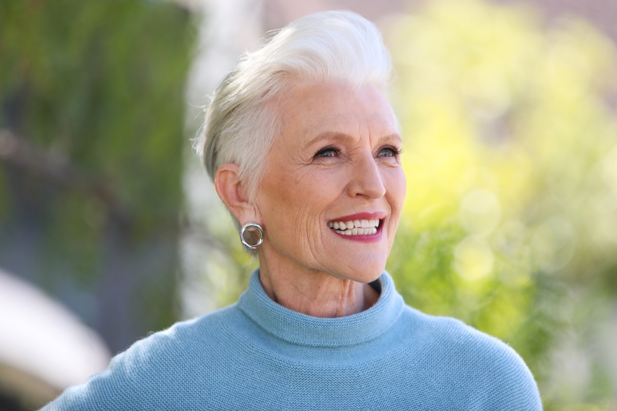 maye musk smiling outside