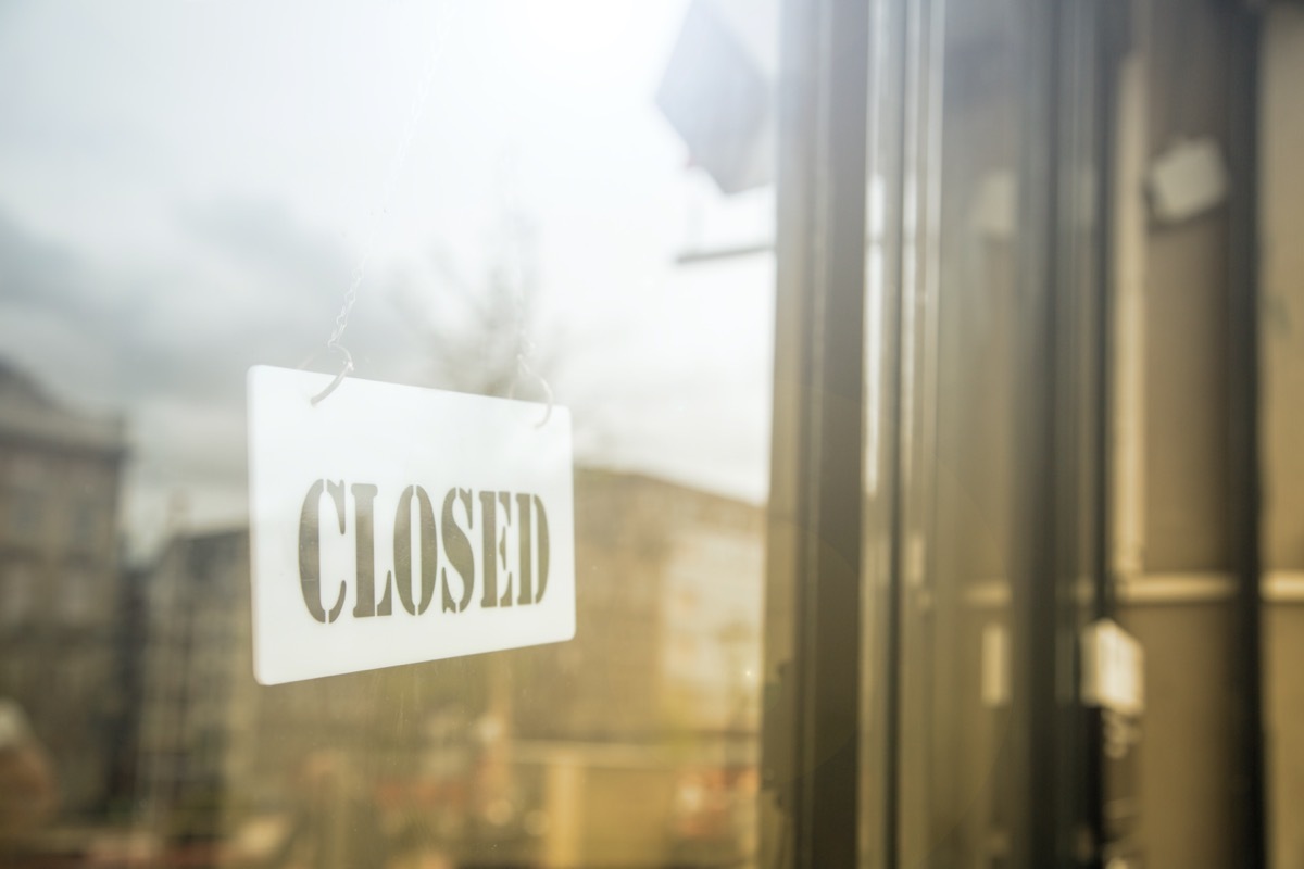 glass door with store closed sign