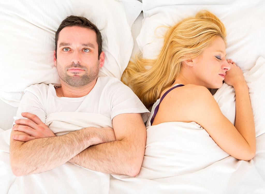 woman asleep man awake couple bed