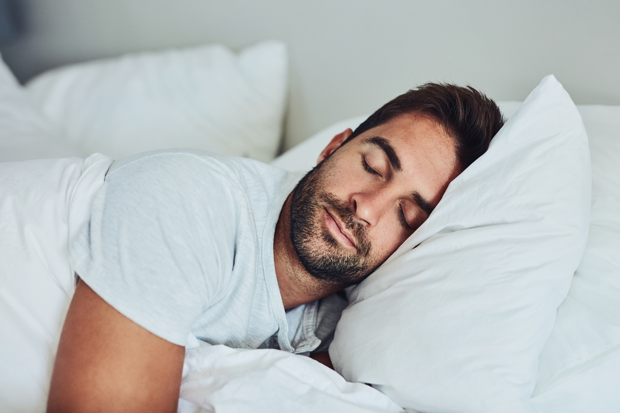 Man sleeping comfortably in bed. 