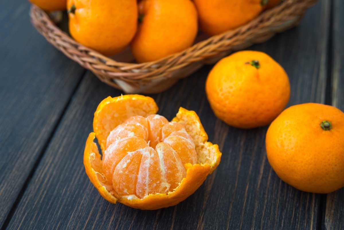 tangerines in bowl and on black background