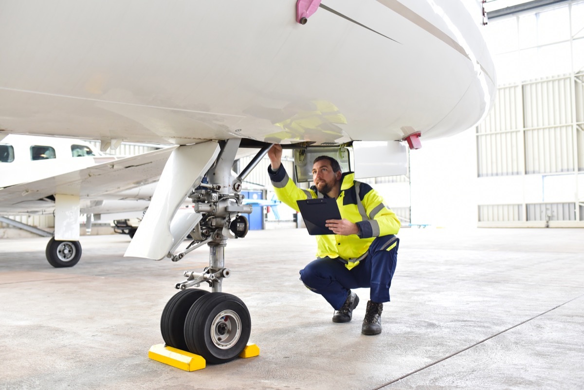 ground personnel inspecting plane