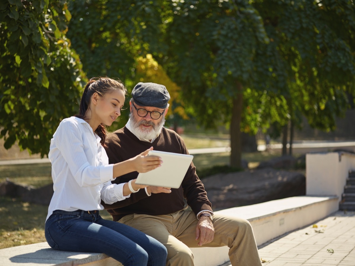 Young Woman Helping Older Man