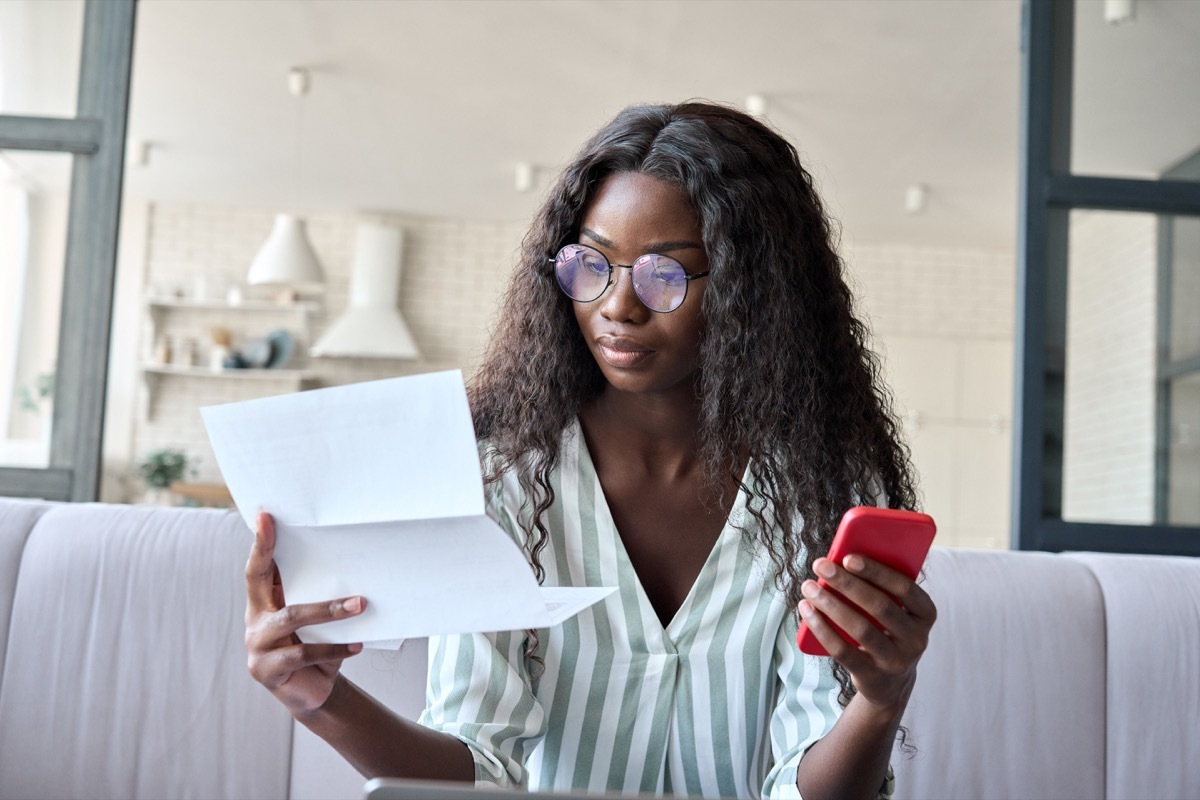 business woman looking at her debt