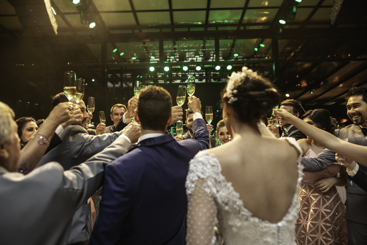 Bride, groom and wedding guests making a toast