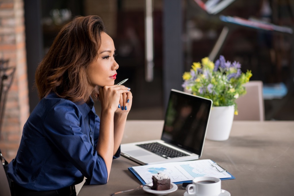 working woman at the office next to her laptop.