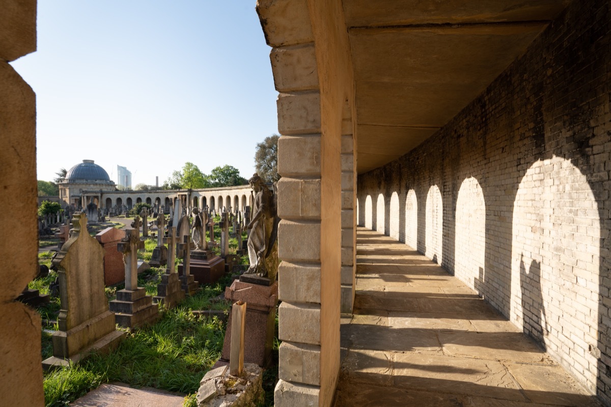 Chapel and graves viewed through arches at Brompton Cemetery