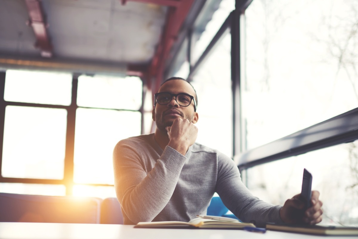 man looking pensive while brainstorming good compliments for girls