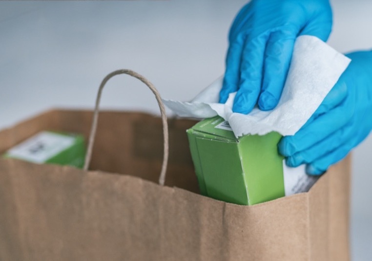 wiping down grocery packages