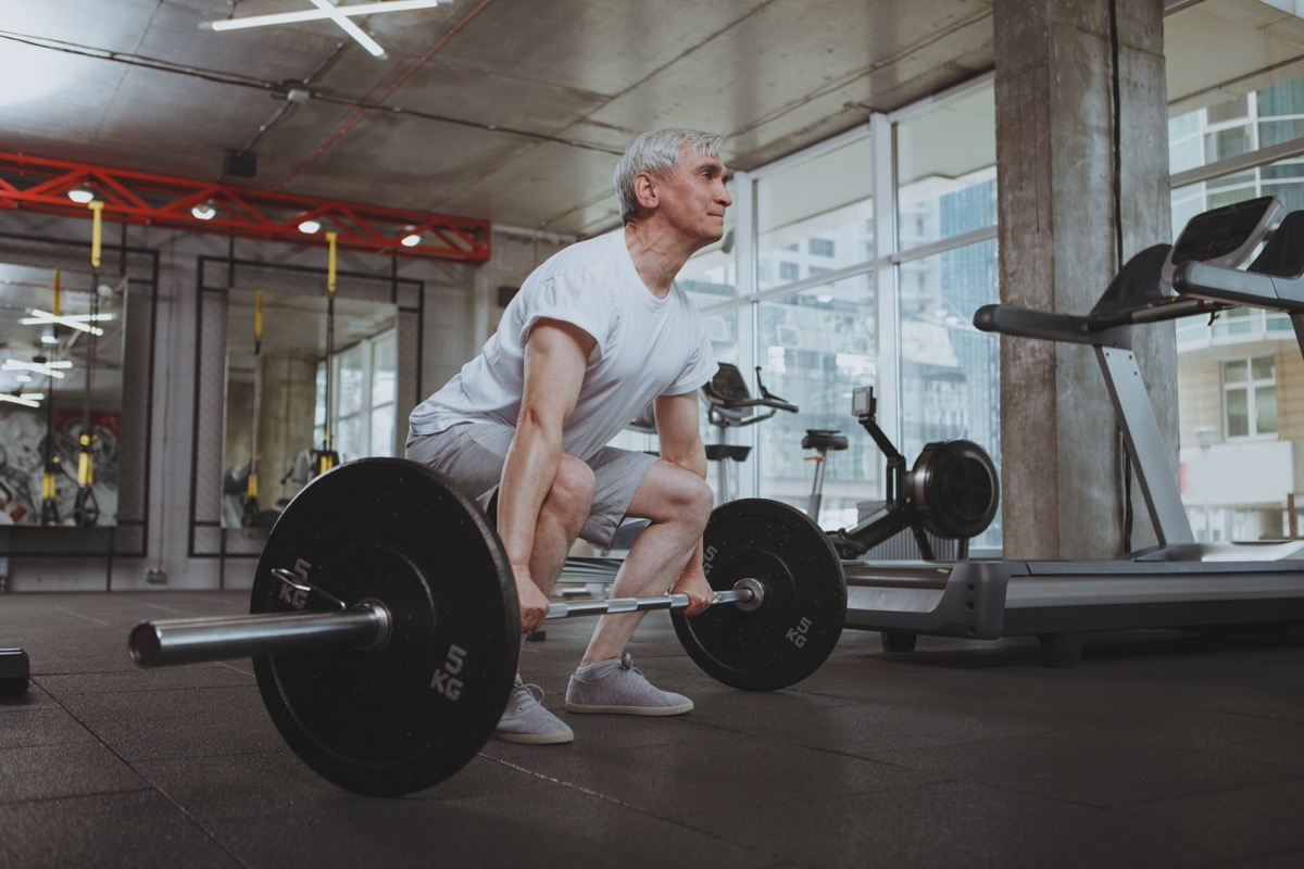 senior man doing deadlifts